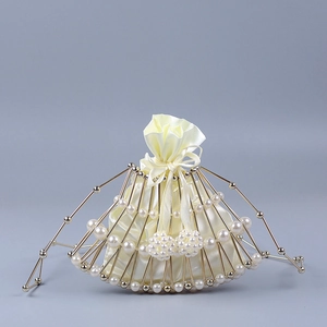 Detail of fan-shaped evening bag with white faux pearls and gold metal frame