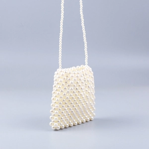 Detail of hand-woven pearl dumpling bag showing intricate bead texture and crossbody strap