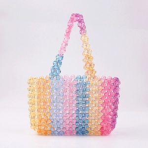 Detailed view of colorful handmade beaded tote bag with rainbow vertical stripe patterns