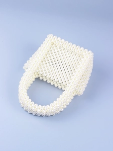 Detailed view of handcrafted white pearl woven handbag with U-shaped handle