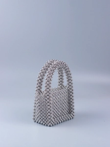 Detailed view of silver metallic beads on a handcrafted mini tote bag with U-shaped handle