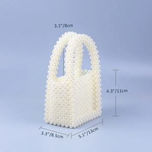 Detailed macro view of handmade mini pearl handbag with precise measurement dimensions