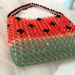 Detail of handmade watermelon beaded bag with red and green acrylic crystal beads