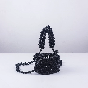 Detail view of handcrafted black acrylic beaded mini bucket bag with chain strap