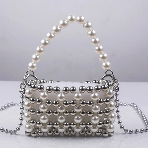 Detail of handmade pearl and silver beaded evening bag with a removable chain strap