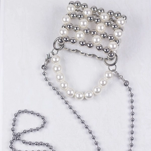 Handmade pearl and silver bead evening bag with dual chain straps on marble