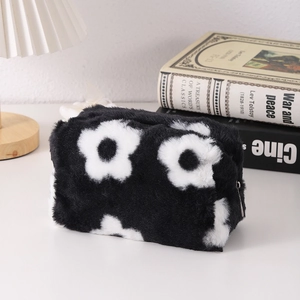 Detail of plush floral pencil case with soft daisy patterns and sturdy zipper closure
