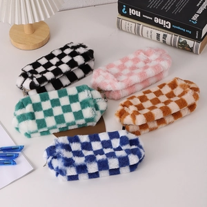 Detailed view of plush checkerboard pencil cases in various colors on a cozy desk setup