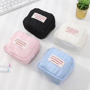 Portable quilted mini cosmetic bags in black, white, pink, and blue colors