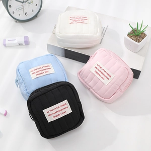 Portable quilted mini cosmetic bags for lipstick in white, blue, pink and black colors