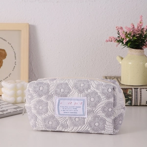 Detailed shot of floral quilted pencil case with top zipper and Sweet Girl label