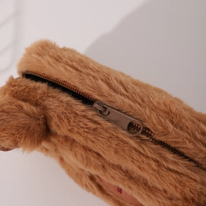 Close-up of the soft brown plush texture and smooth metal zipper of the Capybara pencil case