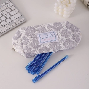 Detail of quilted floral pencil case with soft fabric texture and zipper closure
