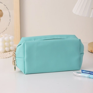 Detail of mint green PU makeup bag featuring cross-grain texture and gold metal zipper