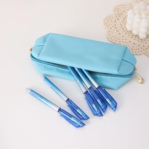 Sky blue PU storage bag with five gradient ink pens on a minimalist white desk setup