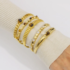 Bohemian gold bangle set with natural tiger eye stone and zircon crystals on wrist