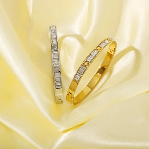 Gold and silver stainless steel bangles with rectangular cubic zirconia and heart motifs