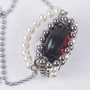 Mini evening pearl handbag with red base, handcrafted beads, and silver crossbody chain