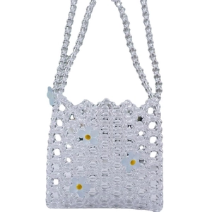 Transparent acrylic beaded crossbody bag featuring three white floral ornaments and chain strap