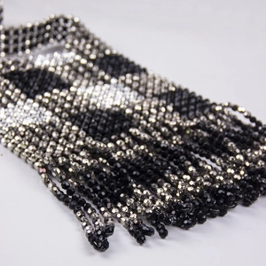 Detail of handmade two-tone acrylic beaded fringe with black and silver faceted mini beads