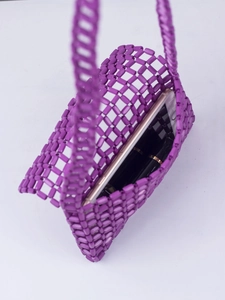 Detail view of purple beaded crossbody bag showing space for smartphone and lipstick