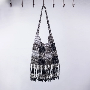 Handmade beaded handbag featuring black and silver checkered patterns with long fringe tassels