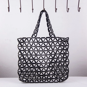 Detail of handmade black acrylic bead tote bag featuring a geometric hollow triangle mesh