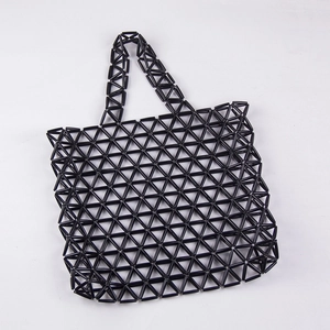 Detail of the geometric triangular grid pattern on the black acrylic beaded tote bag