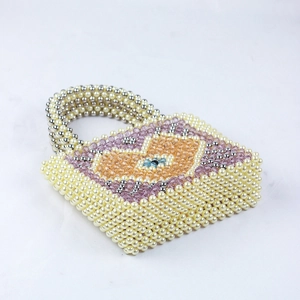 Detail of beaded handbag with pearl beads and colorful evil eye pattern design