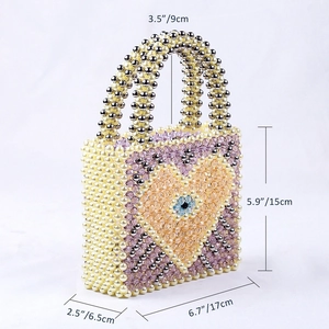 Detail showing dimensions of beaded heart handbag with 17cm width and 15cm height