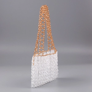Detailed macro view of handcrafted clear acrylic beaded handbag with amber ring handles