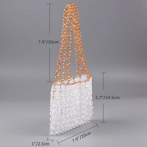 Detail view of handmade beaded handbag with transparent beads and amber handles