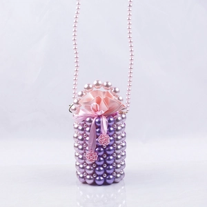 Detailed view of pink and purple handmade pearl bucket bag with satin drawstring lining