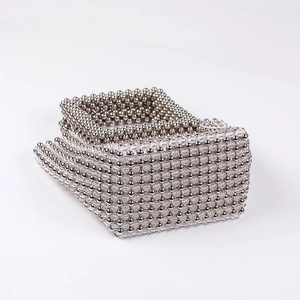 Detailed view of handmade beaded clutch with crystal beads and metallic grid texture