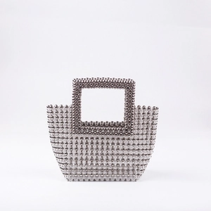 Detail of silver metallic and clear beads on a handcrafted evening clutch bag