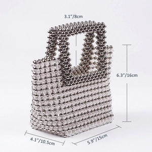 Detail view of handmade beaded evening bag with precise dimensions and silver bead texture
