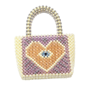 Handmade beaded handbag with heart pattern and evil eye detail for party use