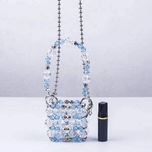 Mini handmade acrylic beaded handbag in blue and white with a thin metal chain strap