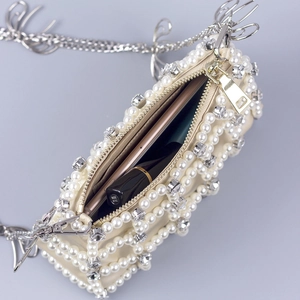 Elegant pearl and rhinestone crossbody bag with gold zipper and silver butterfly detail