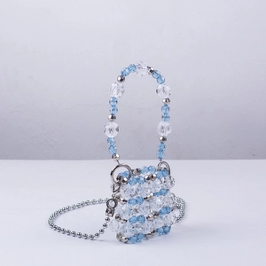 Detail of mini handmade beaded bag with light blue and clear acrylic faceted beads