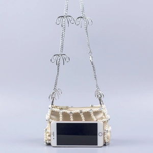 Elegant beaded crossbody bag with pearls, rhinestones, and bow metal chain strap