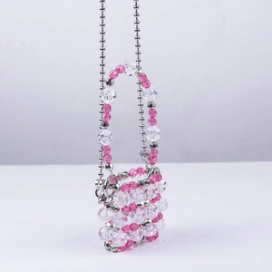 Detailed view of handmade pink and clear acrylic beads with a silver metallic chain