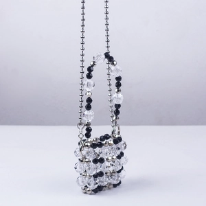 Detailed view of handmade beaded mini bag with acrylic crystals and metal ball chain strap