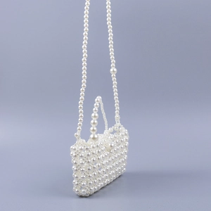 Detailed side view of handcrafted pearl woven crossbody bag with elegant bead texture