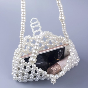 Handmade hollow pearl beaded crossbody phone bag in cream white showing storage capacity
