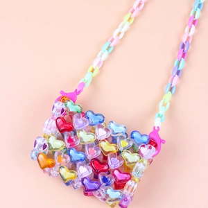Detailed shot of handmade mini crossbody bag with colorful heart-shaped acrylic beads