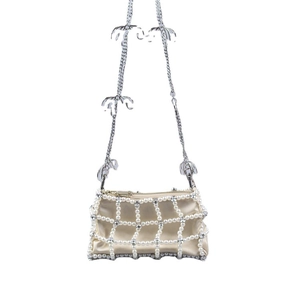 Elegant pearl lattice crossbody bag with palm tree charms on a silver chain strap