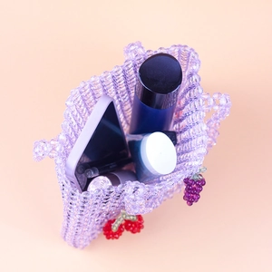 Handmade purple acrylic beaded handbag with fruit charms and daily essentials inside