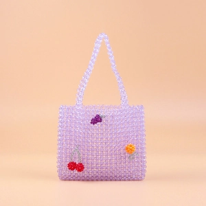 Detail of handmade beaded tote with 3D acrylic fruit charms and purple beads