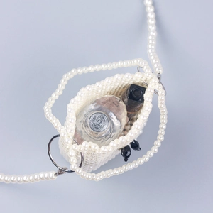 Mini pearl woven bucket bag with long crossbody chain strap and stylish white finish